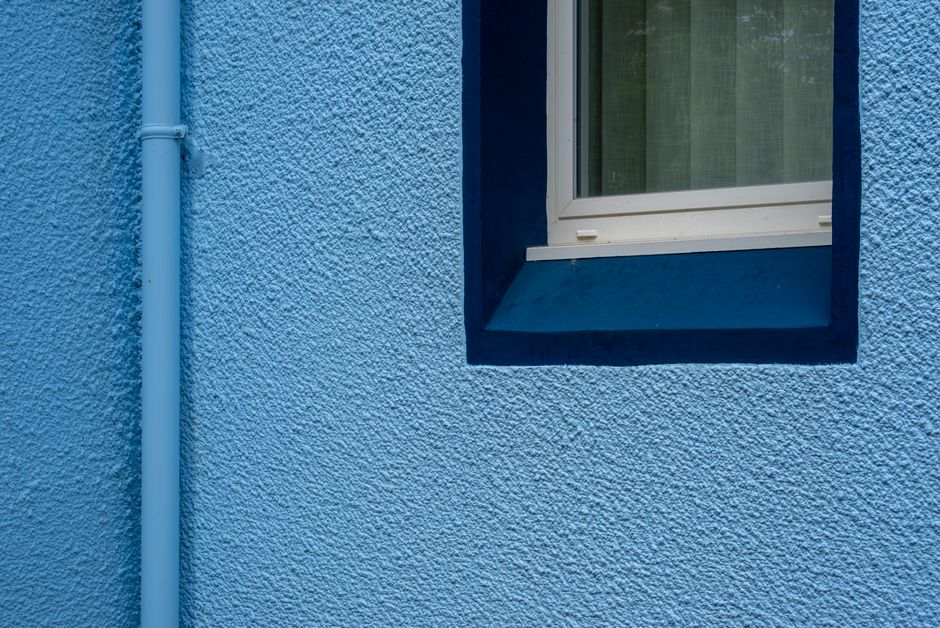 Painted exterior wall of a home in sunlight