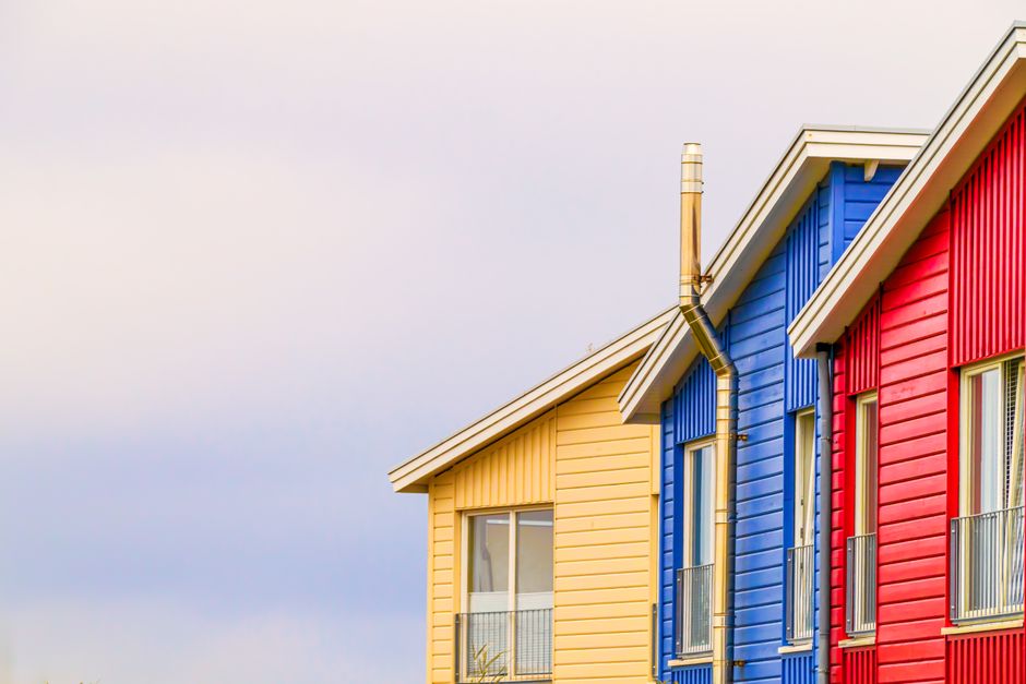 Painted house front with trim and a door